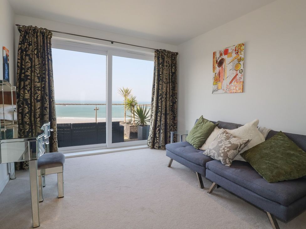 A living room with a sofa and sea view at The View in Newquay