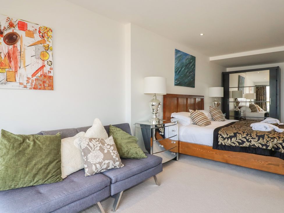 A bedroom with a sofa and bed at The View in Newquay