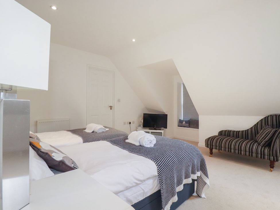 A bedroom with two beds and a television at The View in Newquay