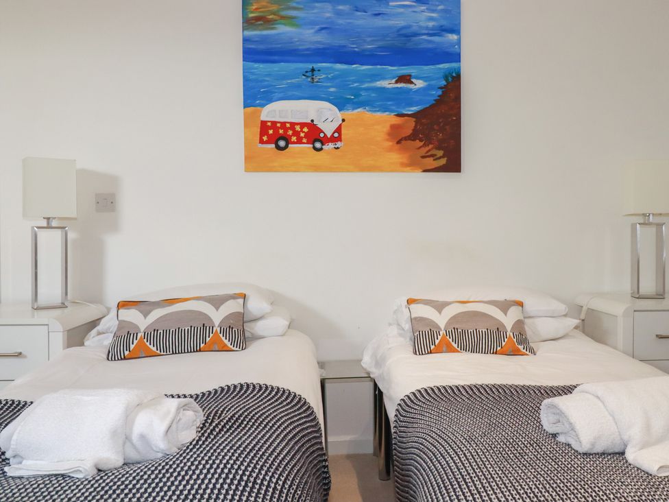 A bedroom with two beds and a painting at The View in Newquay