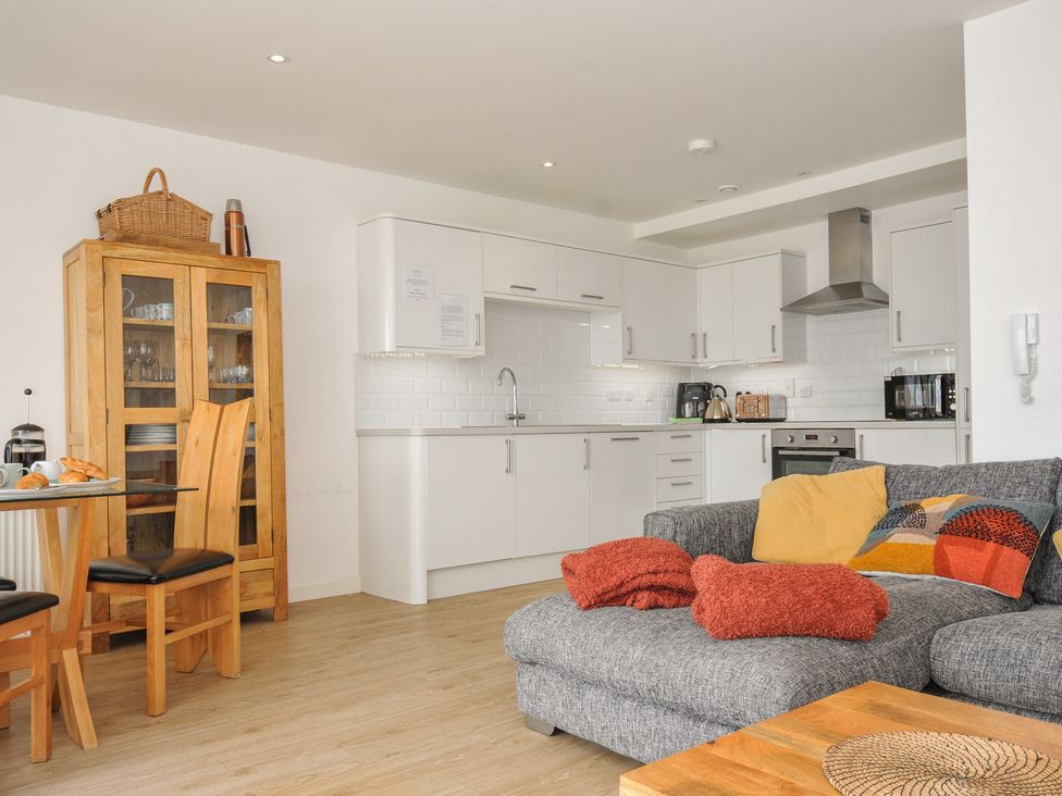 A kitchen with a dining table and sofa at The View in Newquay