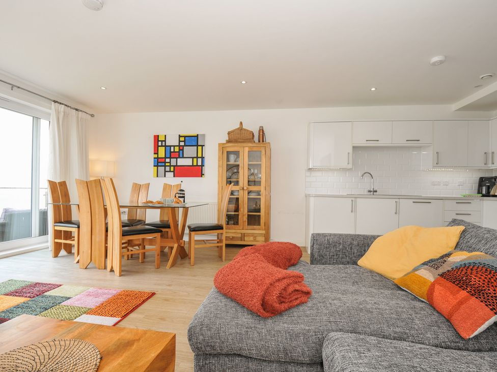A living room with a dining area and kitchen units at The View in Newquay
