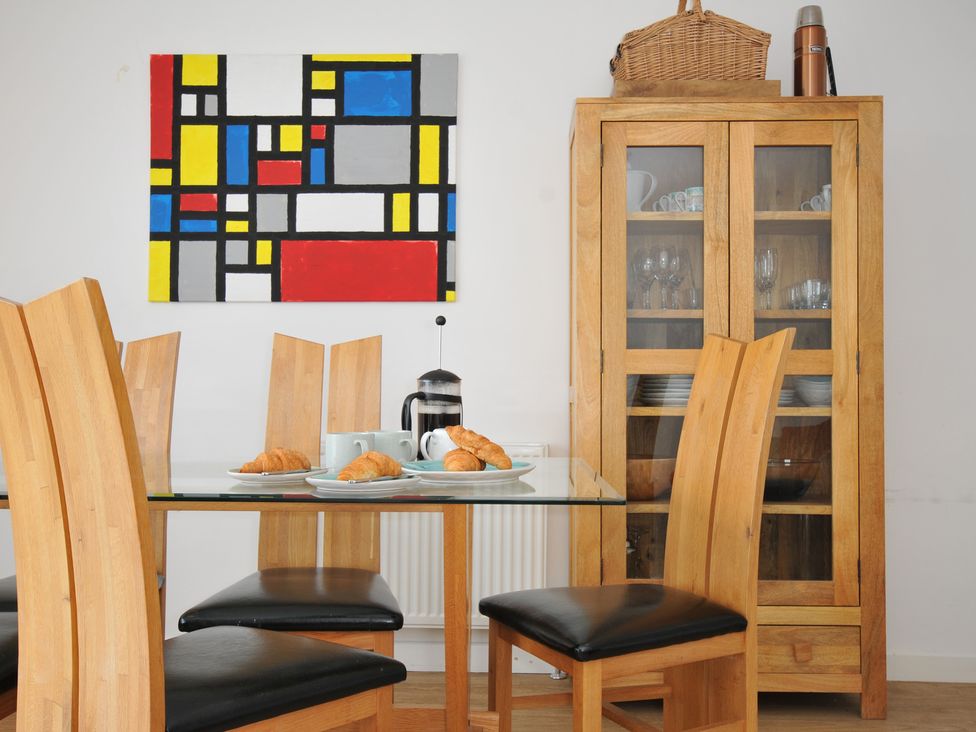 A dining room with a table and chairs at The View in Newquay