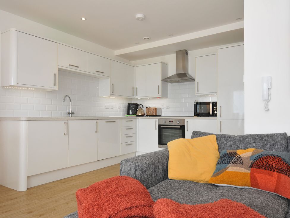 A kitchen with modern cabinets and appliances at The View in Newquay