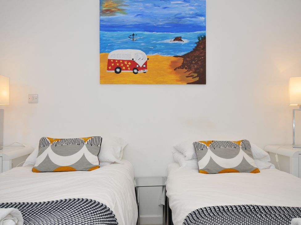 A bedroom with two beds and a painting at The View in Newquay