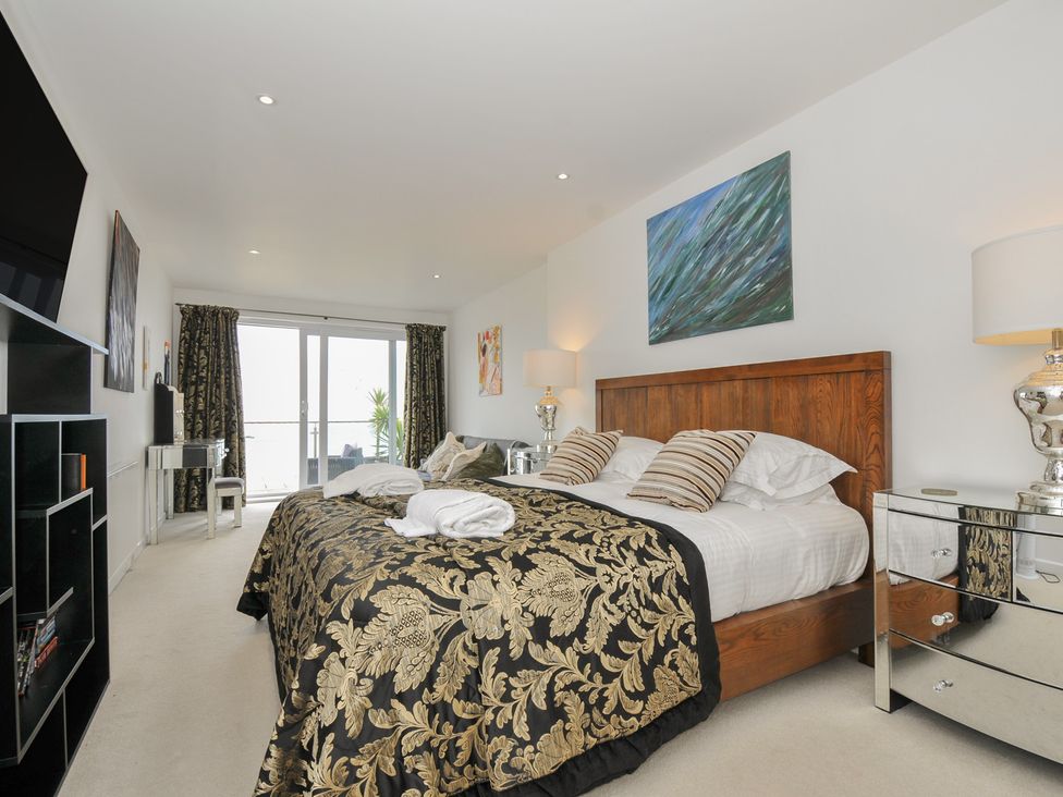 A bedroom with a bed and television at The View in Newquay