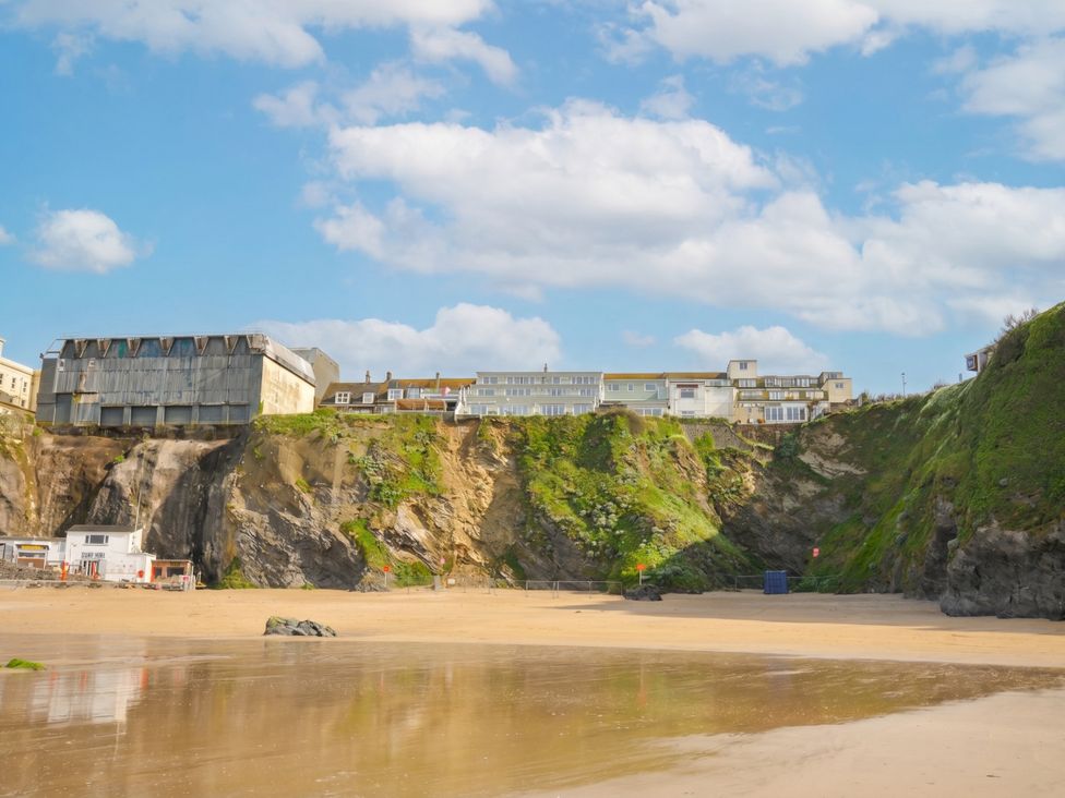 A beach with cliffs and buildings in the background at The View in Newquay