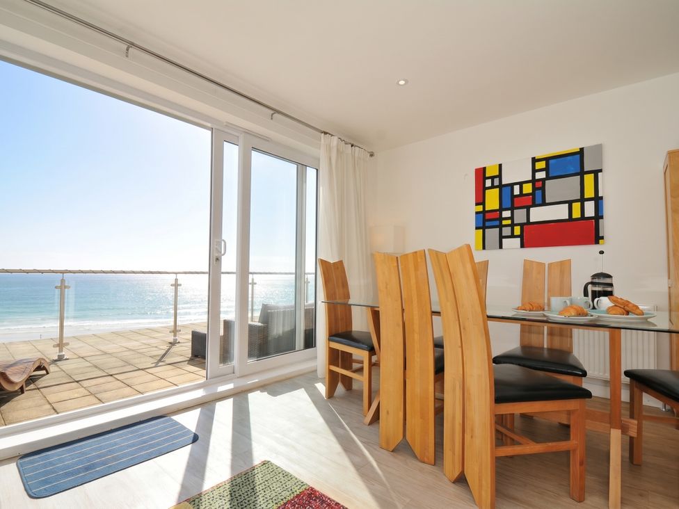 A dining area with a view of the sea at The View in Newquay