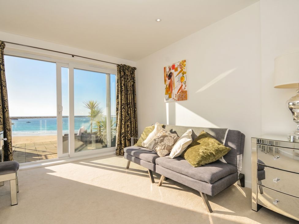 A living room with a sofa and sea view at The View in Newquay