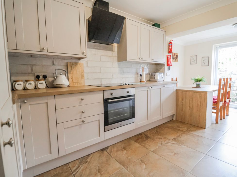 A kitchen with cabinets and appliances at Riverlea in Dyserth