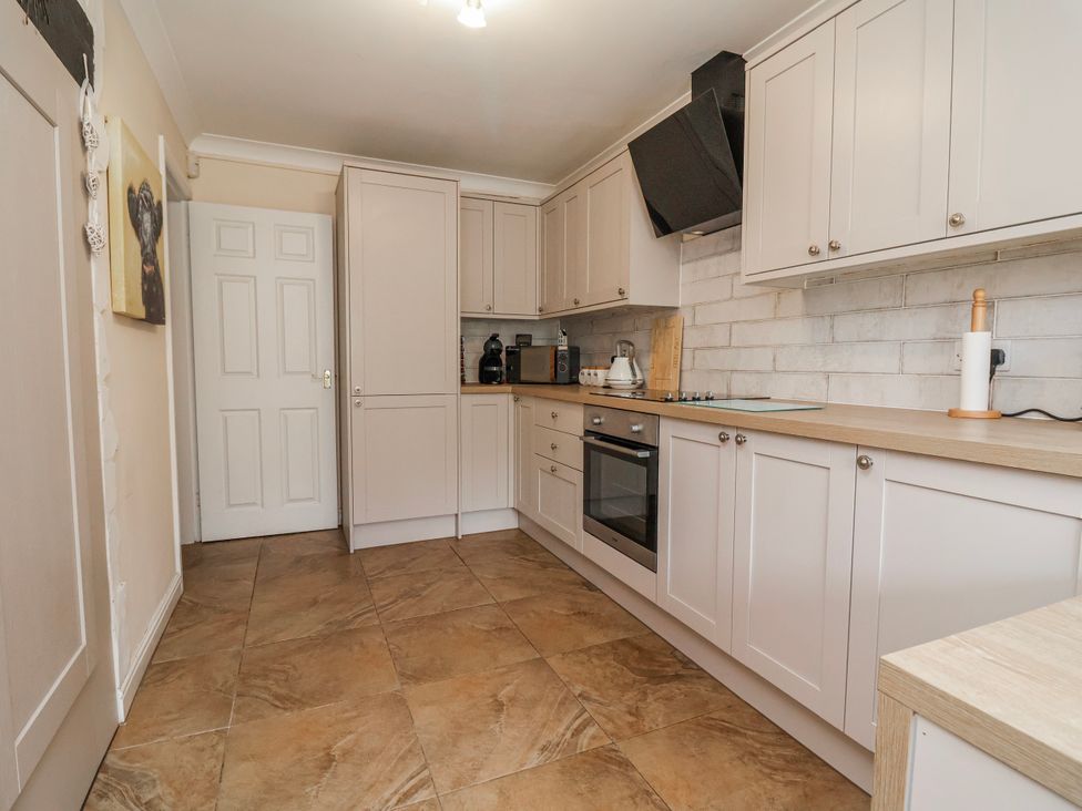A kitchen with cabinets and appliances at Riverlea in Dyserth