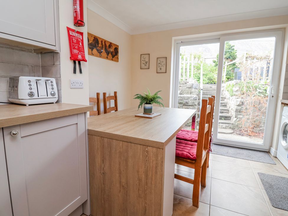A kitchen with a table and chairs at Riverlea in Dyserth