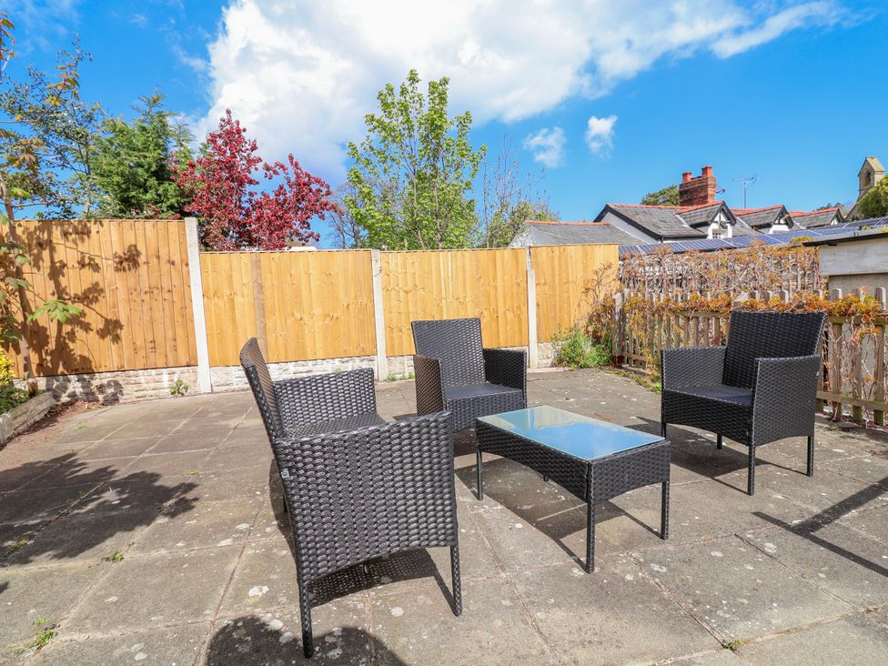 An outdoor seating area with chairs and a table at Riverlea in Dyserth
