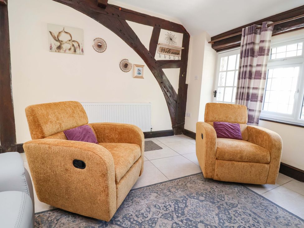 A living room with two recliner chairs and a window at Ty Cerrig in Dyserth
