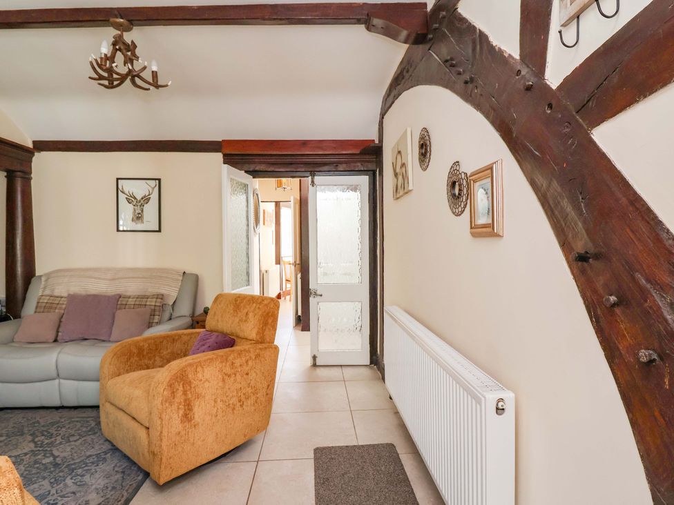 A living room with a sofa and armchair at Ty Cerrig in Dyserth