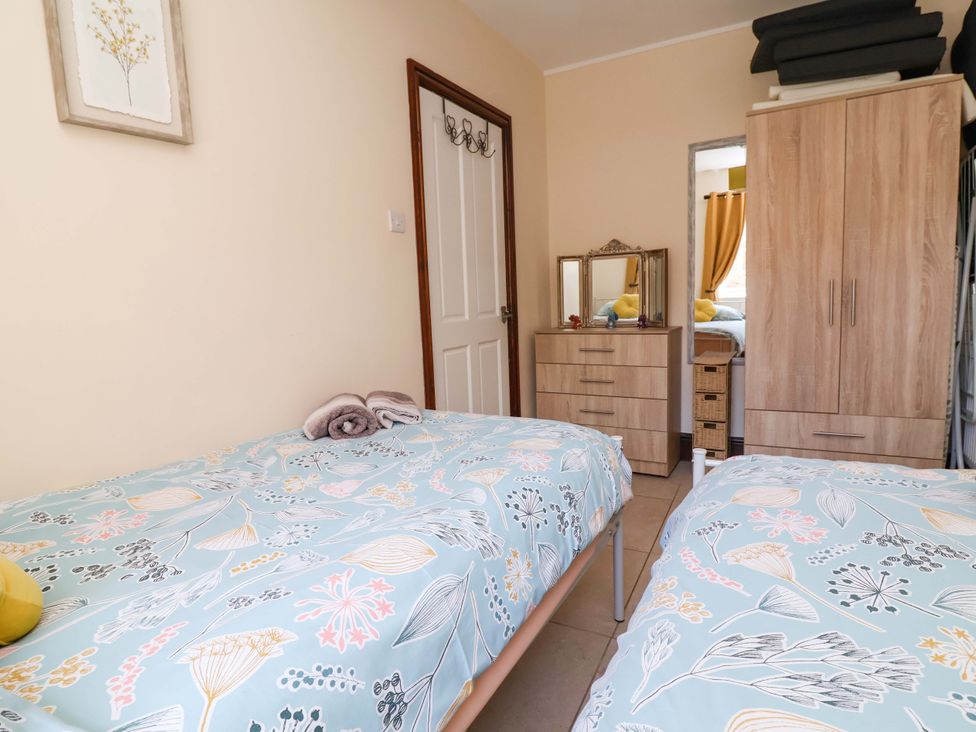 A bedroom with two beds and furniture at Ty Cerrig in Dyserth