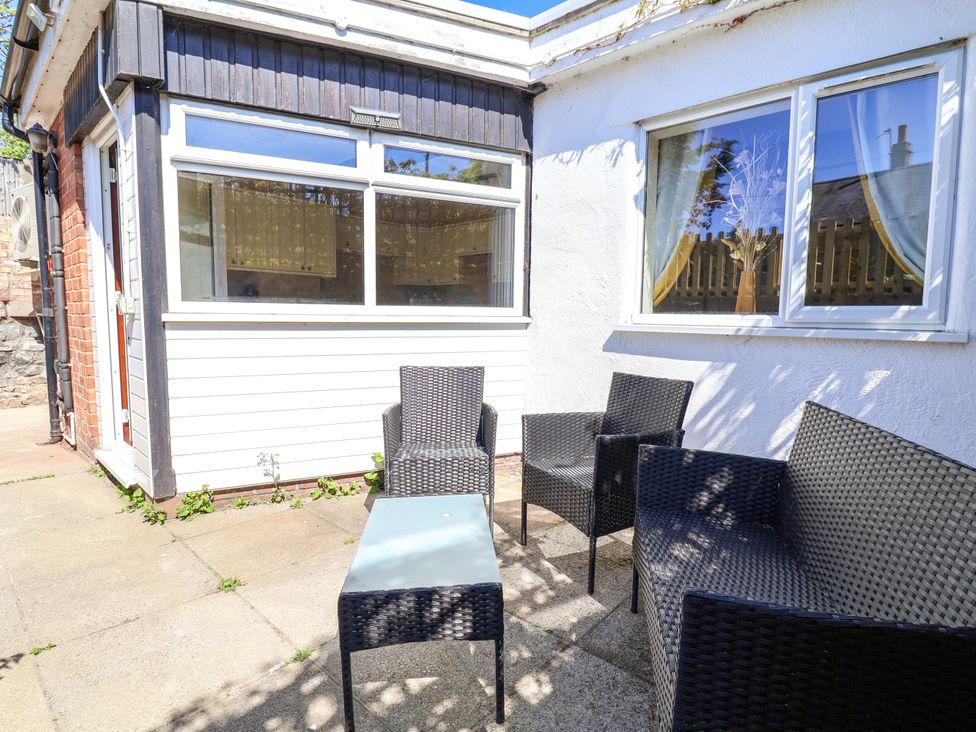 An outdoor seating area with chairs and a table at Ty Cerrig in Dyserth