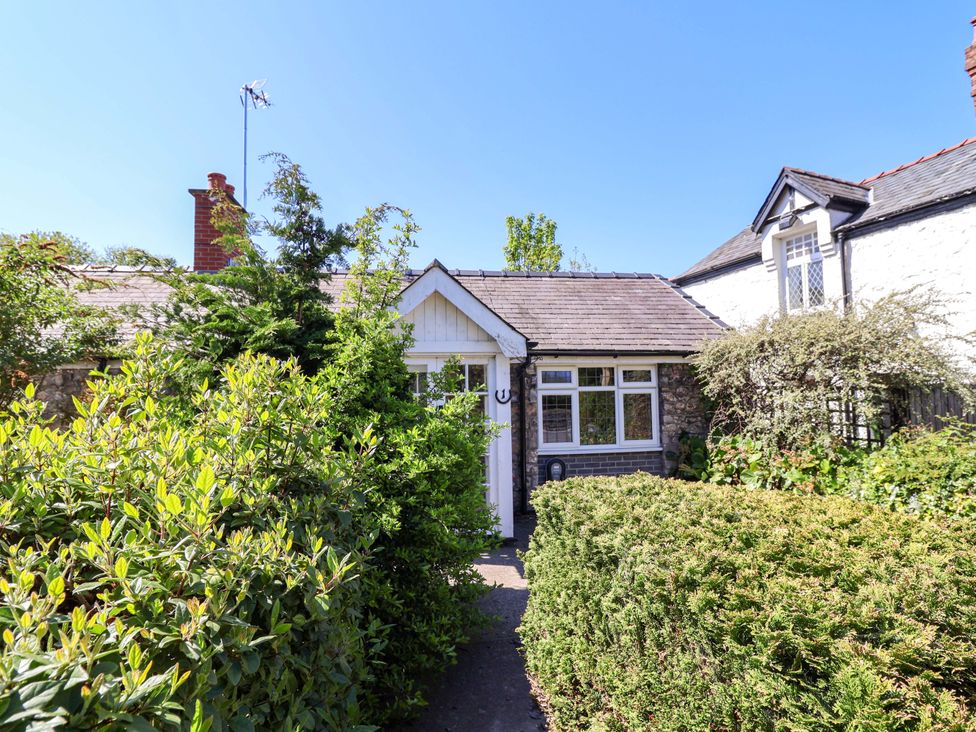 A house with a front door and bushes at Ty Cerrig in Dyserth