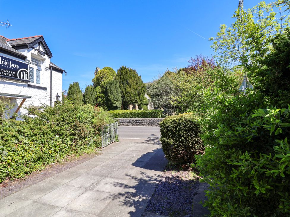 An outdoor view of a building and pathway at Ty Cerrig in Dyserth