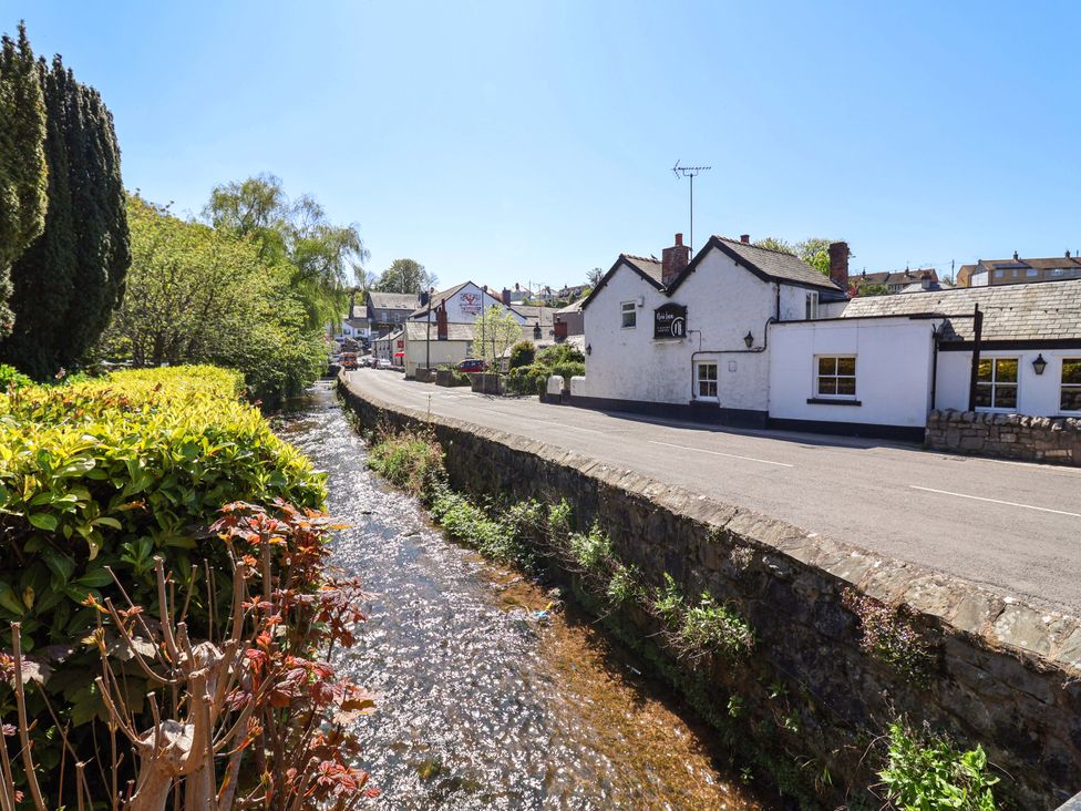 A street view with water beside road at Ty Cerrig in Dyserth