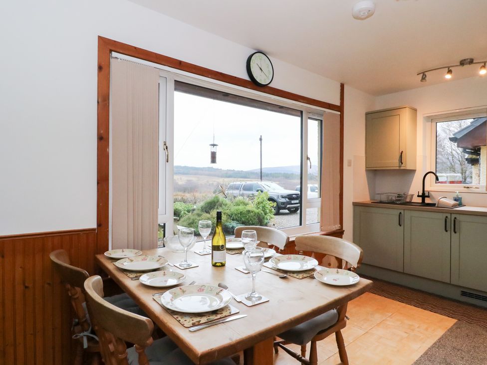 A dining room with a table set for meals at Alba Ben View in Spean Bridge