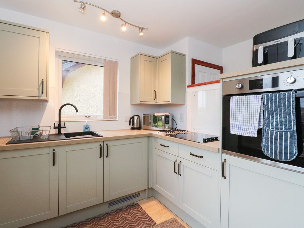 A kitchen with cabinets and appliances at Alba Ben View in Spean Bridge