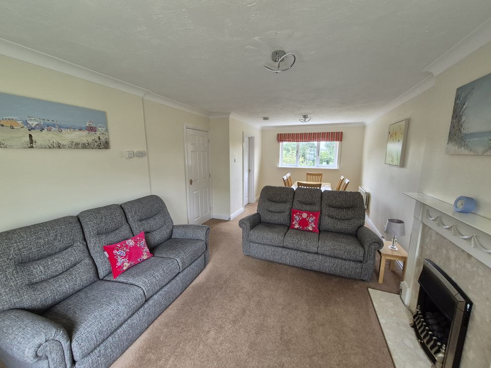 A living room with sofas and a dining table at 12 Kel Avon in Truro