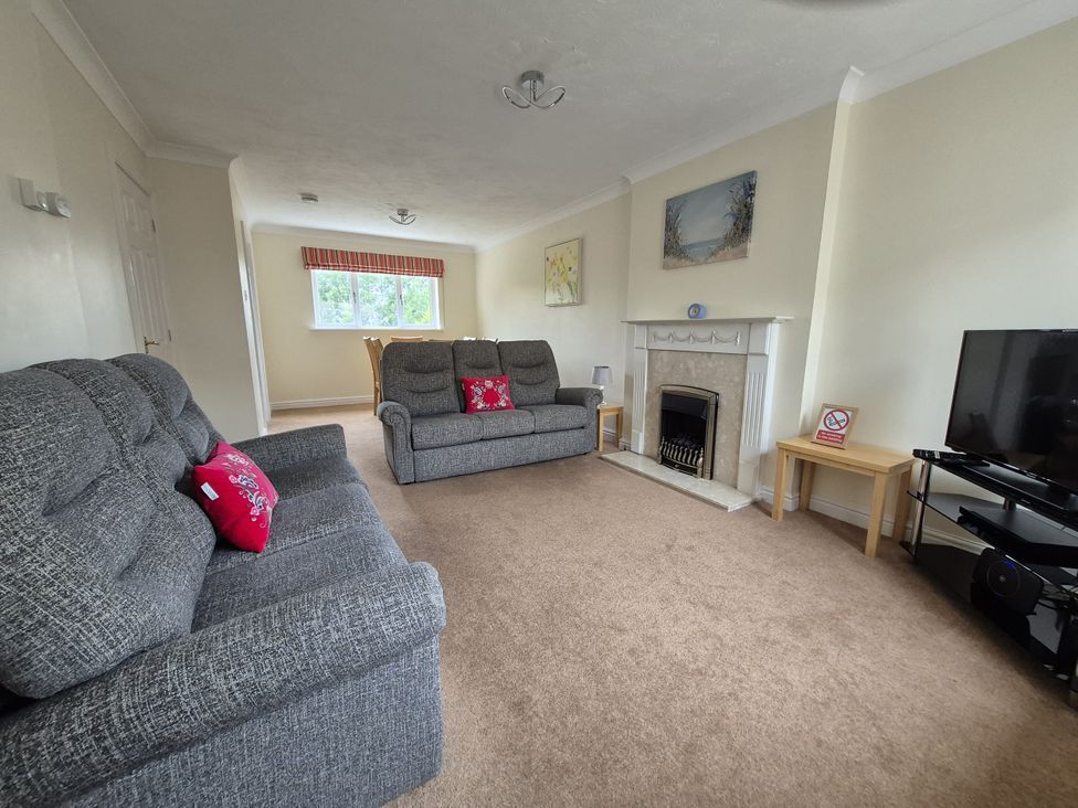 A living room with sofas and a fireplace at 12 Kel Avon in Truro
