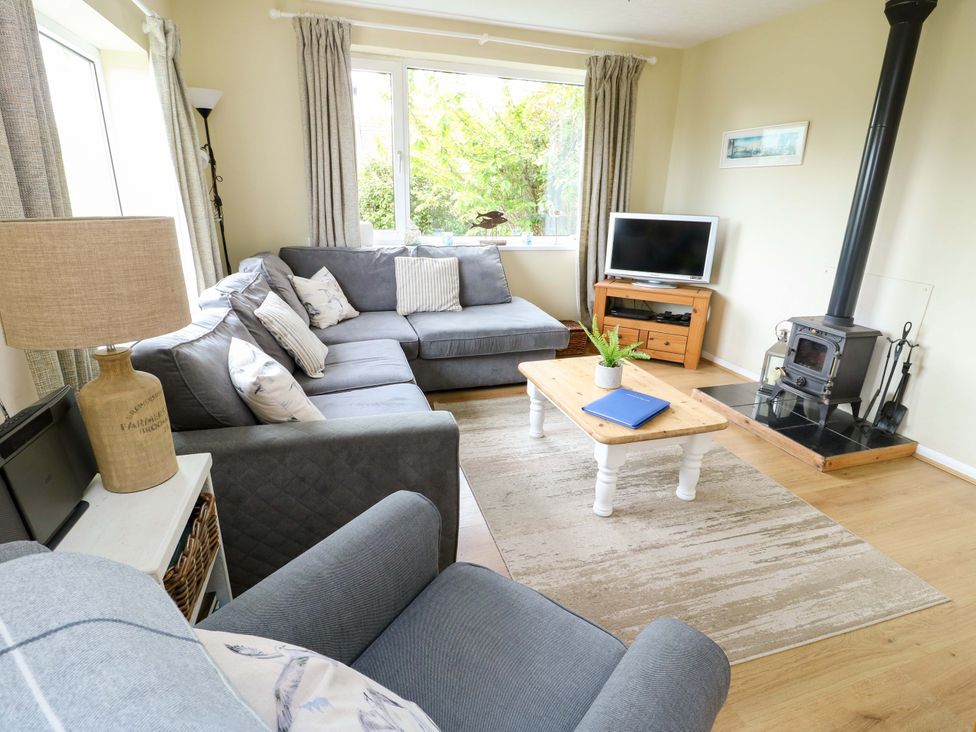 A living room with a sofa and coffee table at Sea View in Benllech