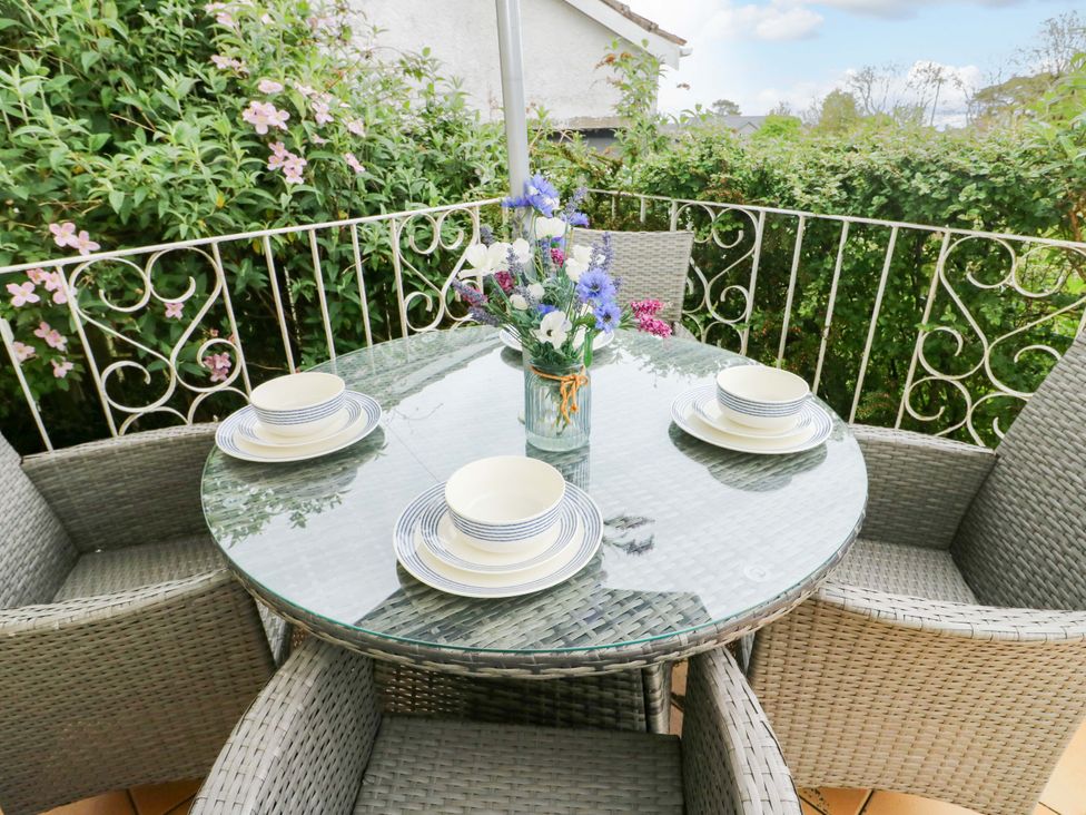 An outdoor seating area with a table and chairs at Sea View in Benllech