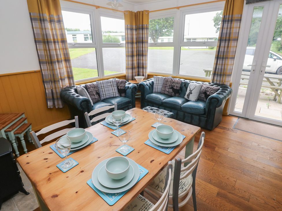 A dining room with a table set for meals at Driftwood in Roch
