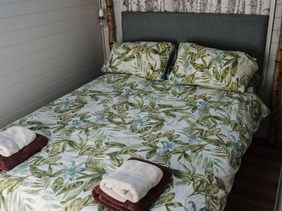 A bedroom with a bed and pillows at Reflection in Longtown