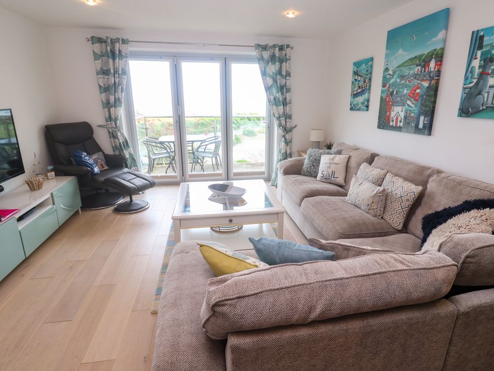 A living room with a sofa and coffee table at Ocean Seven in Newquay