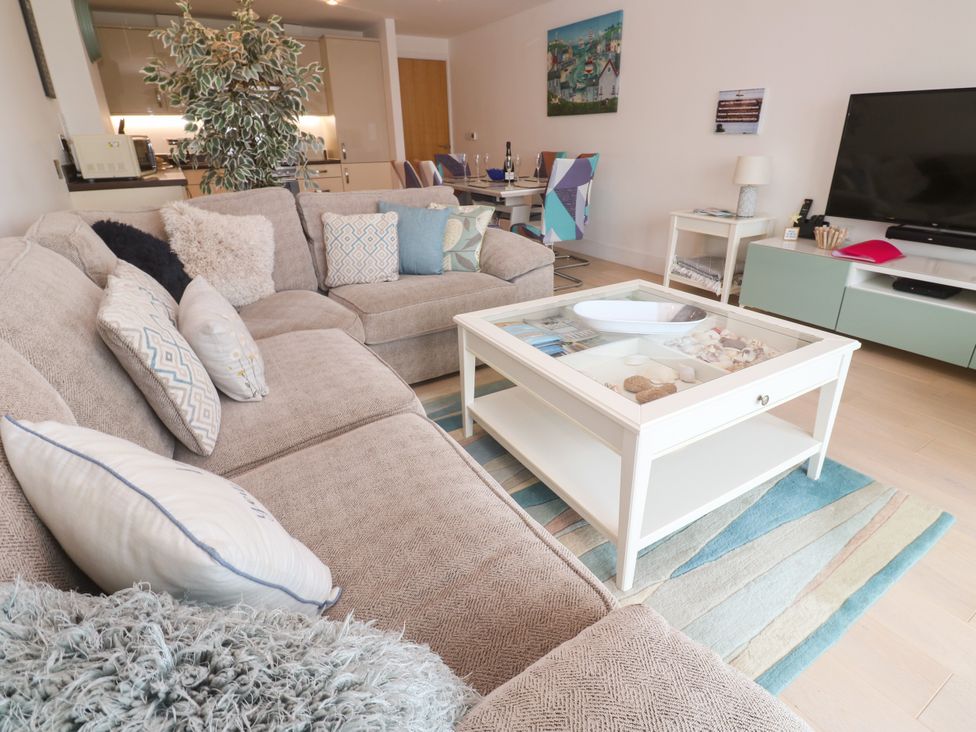 A living room with a coffee table and sofa at Ocean Seven in Newquay