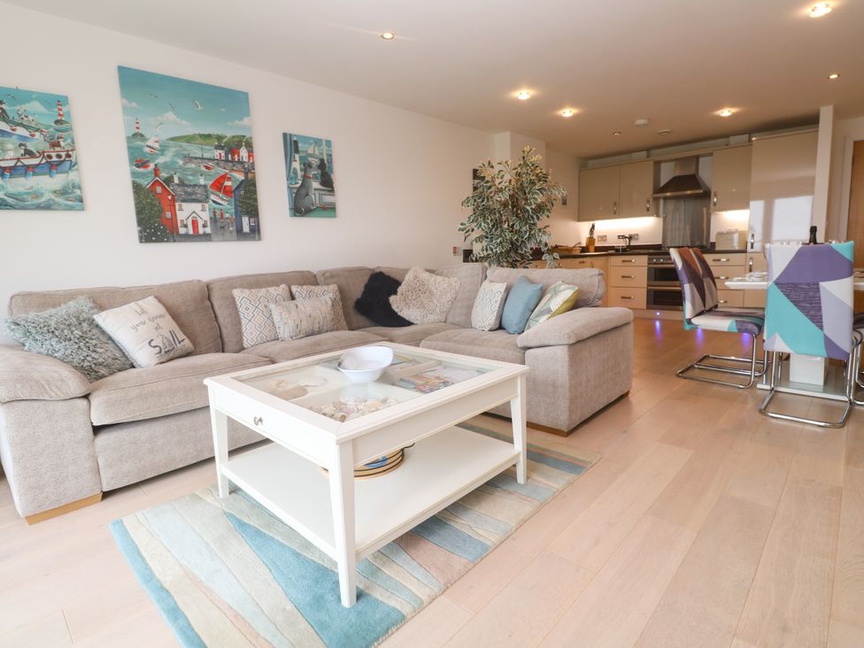 A living room with a sofa and coffee table at Ocean Seven in Newquay