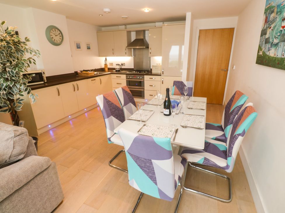 A dining room with a table and chairs at Ocean Seven in Newquay