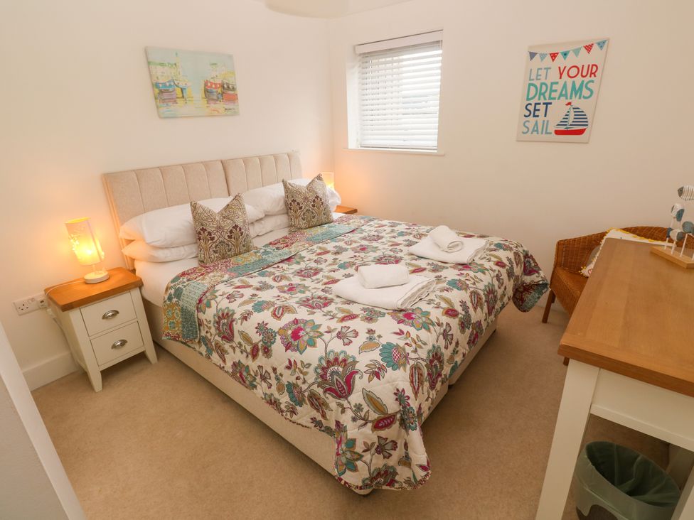 A bedroom with a bed and nightstand at Ocean Seven in Newquay