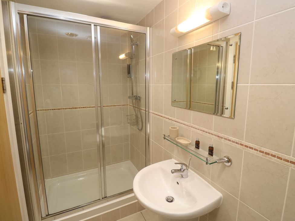 A bathroom with a shower and sink at Ocean Seven in Newquay