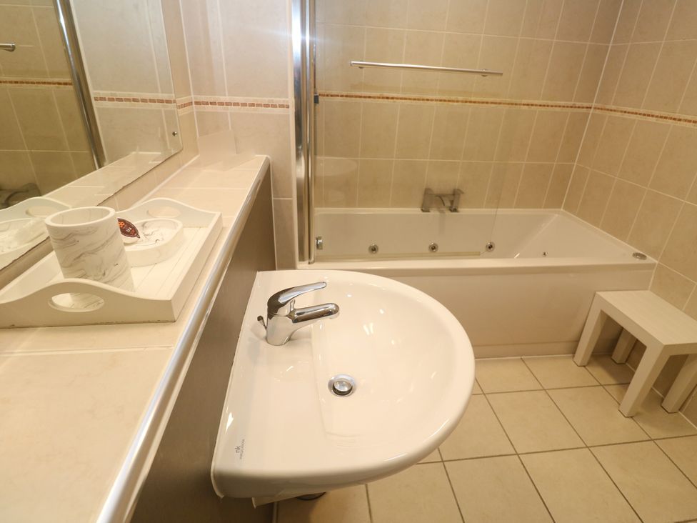 A bathroom with a sink and bath tub at Ocean Seven in Newquay