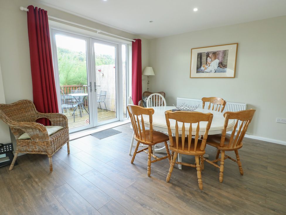 A dining room with a table and chairs at Awelon in Rhos-On-Sea