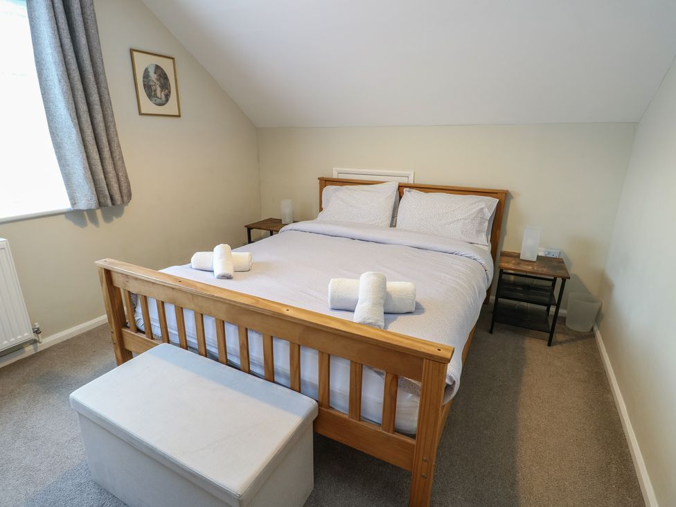 A bedroom with a bed and bedside table at Awelon in Rhos-On-Sea