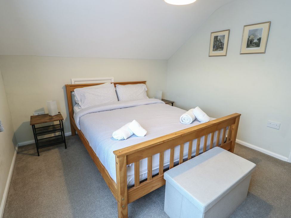 A bedroom with a bed and bedside table at Awelon in Rhos-On-Sea