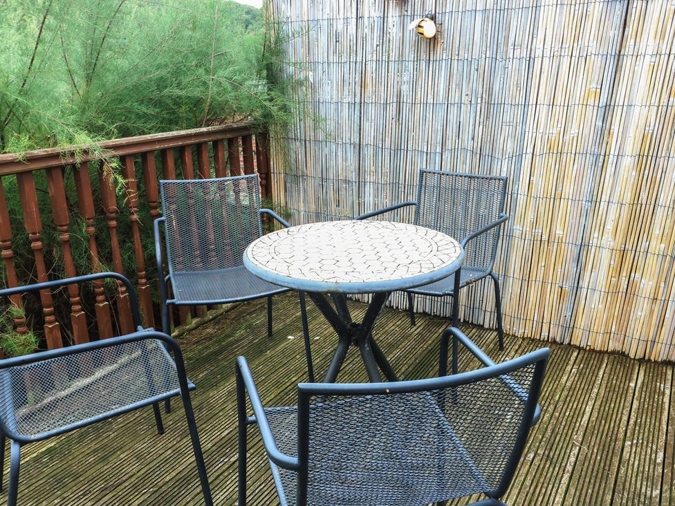 An outdoor seating area with a table and chairs at Awelon in Rhos-On-Sea