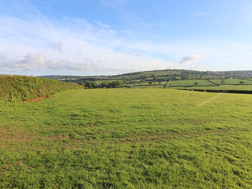 A landscape view with grass and hills at Cedar Lodge in Lanivet near Bodmin