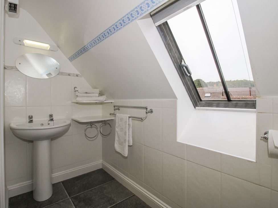 A bathroom with sink and mirror at Wash House Cottage in Much Wenlock