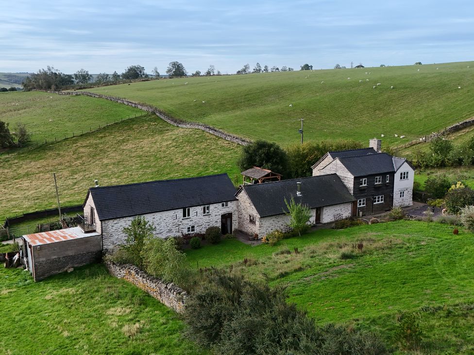 An aerial view of a property with fields and trees at Pant Dafydd Goch in Llangollen