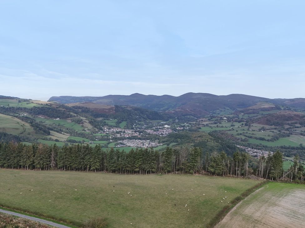 A landscape view of fields and mountains at Pant Dafydd Goch in Llangollen