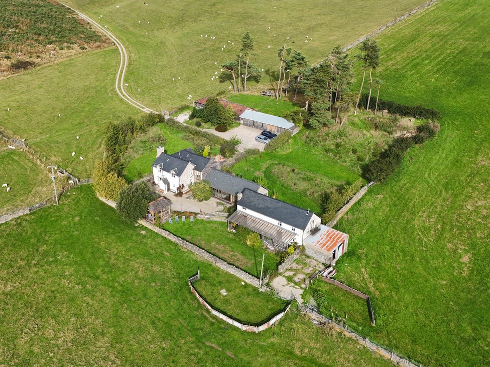 An aerial view of a house and yard with trees at Pant Dafydd Goch in Llangollen