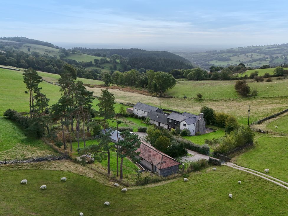 An aerial view of a farmhouse surrounded by fields at Pant Dafydd Goch Llangollen
