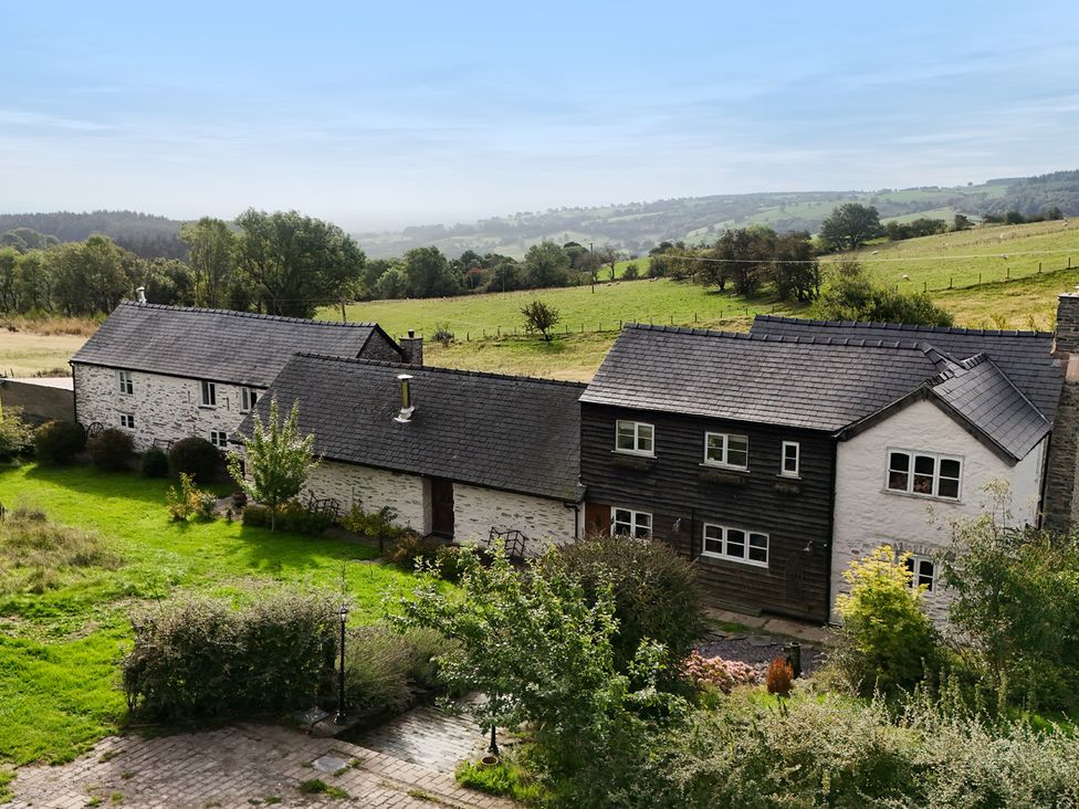 A house with a garden and fields in the background at Pant Dafydd Goch in Llangollen